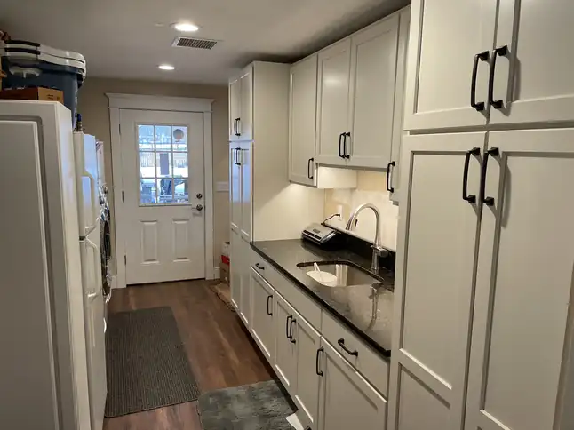 Finished galley kitchen with a back door at the far end