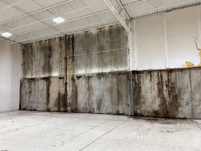 Commercial warehouse wall stained by a flood line and mold