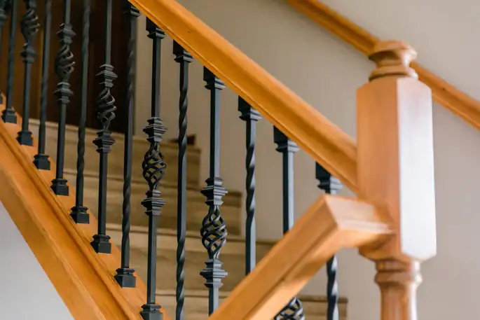 Custom staircase with wrought-iron balusters and a wood handrail