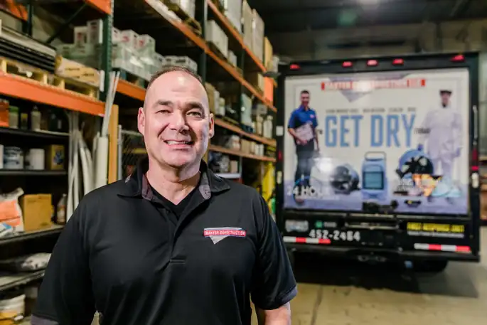 Portrait of Brice Baxter in the warehouse in front of a Baxter truck wrap